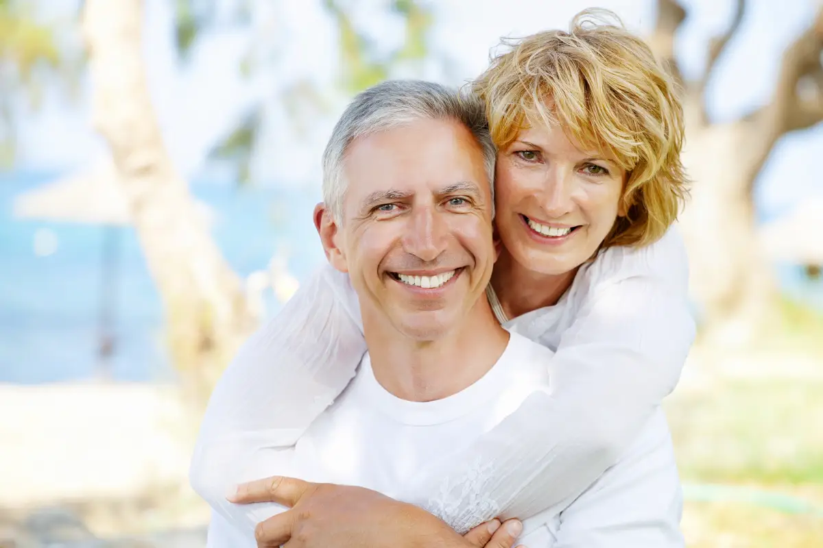 phoenix man smiling after getting implant dentures from skilled implant dentist