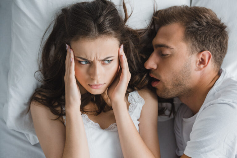 man snoring in his partners ear, possible sleep apnea sufferer