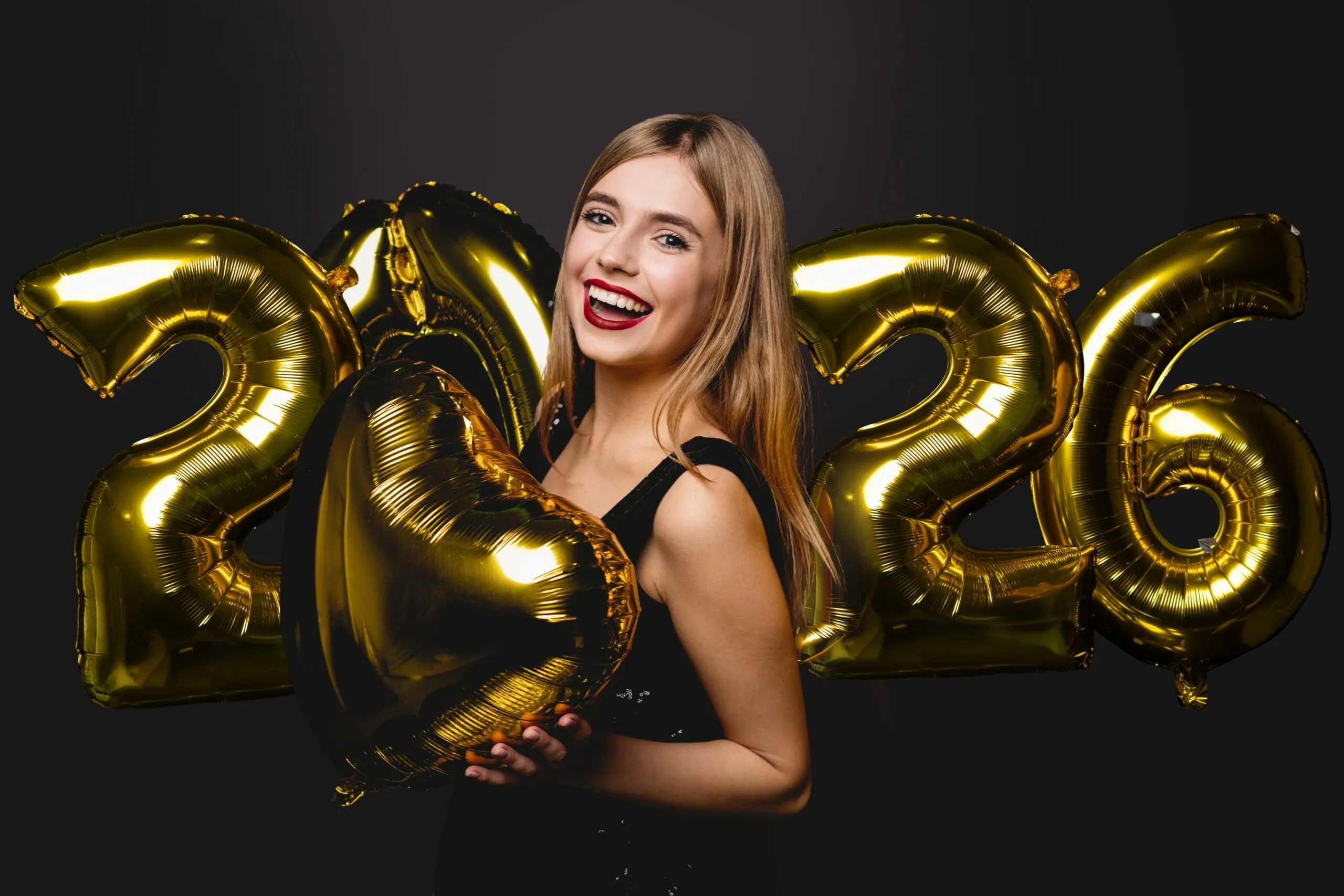 smiling woman holding 2026 new years balloons, perfect white smile