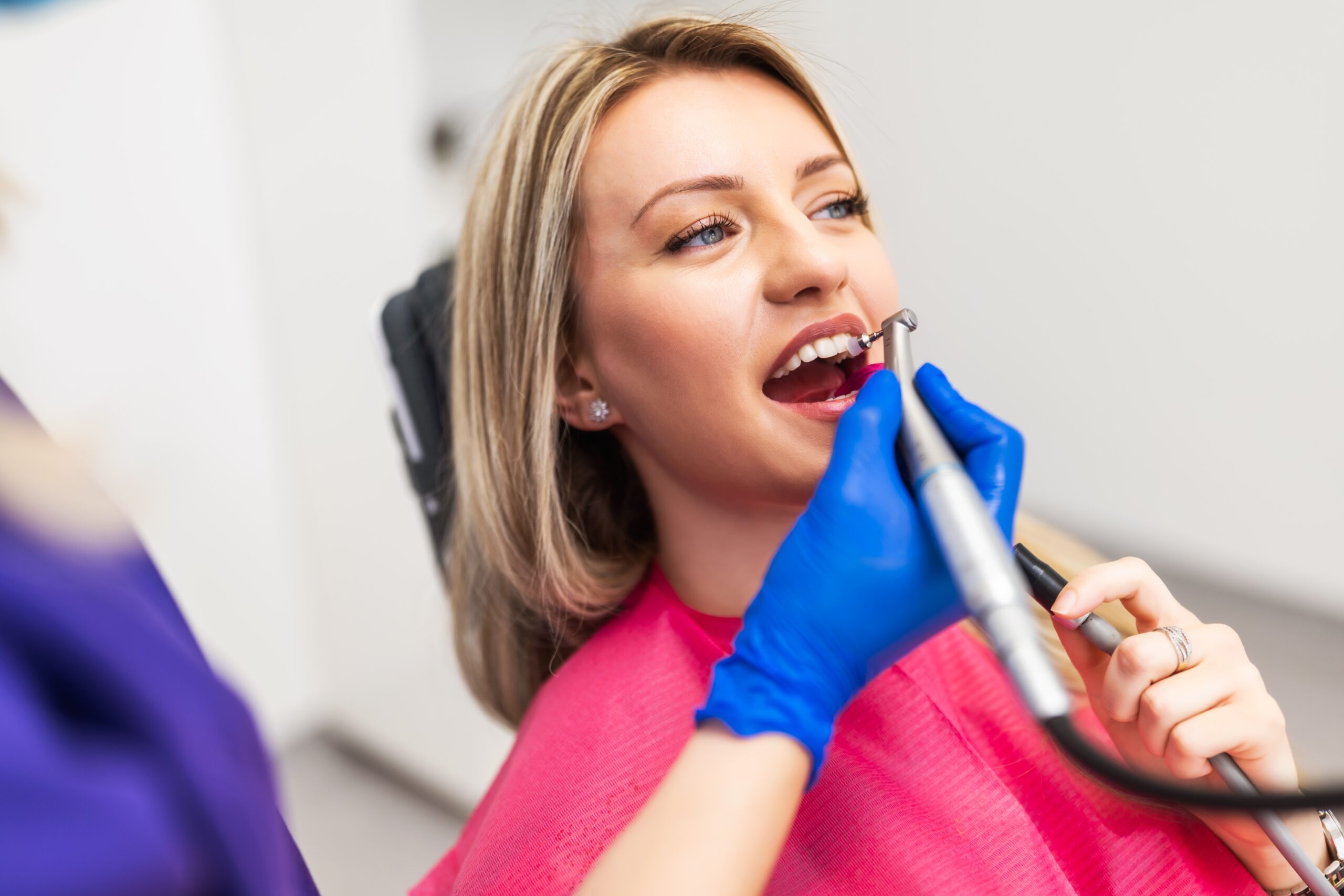 young woman having her dental crown polished